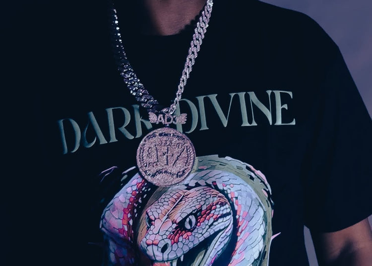 Person wearing a black t-shirt with a colorful snake design and 'Dark Divine' text.
